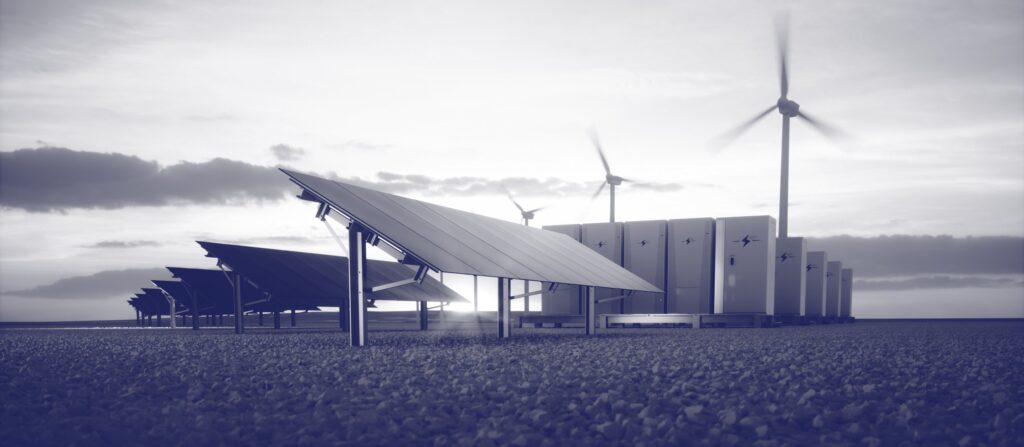 grey scale image of solar panels and windfarm.